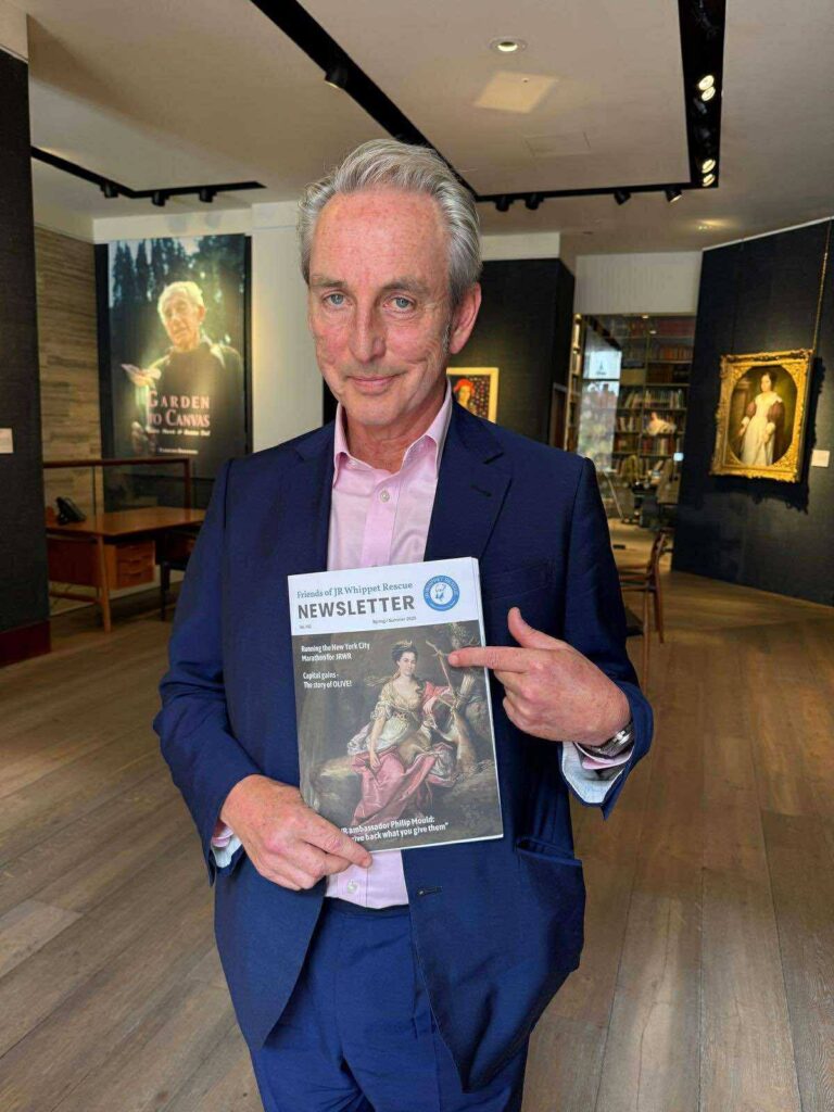 Photo of Philip Mould holding a copy of the JR Whippet Rescue newsletter